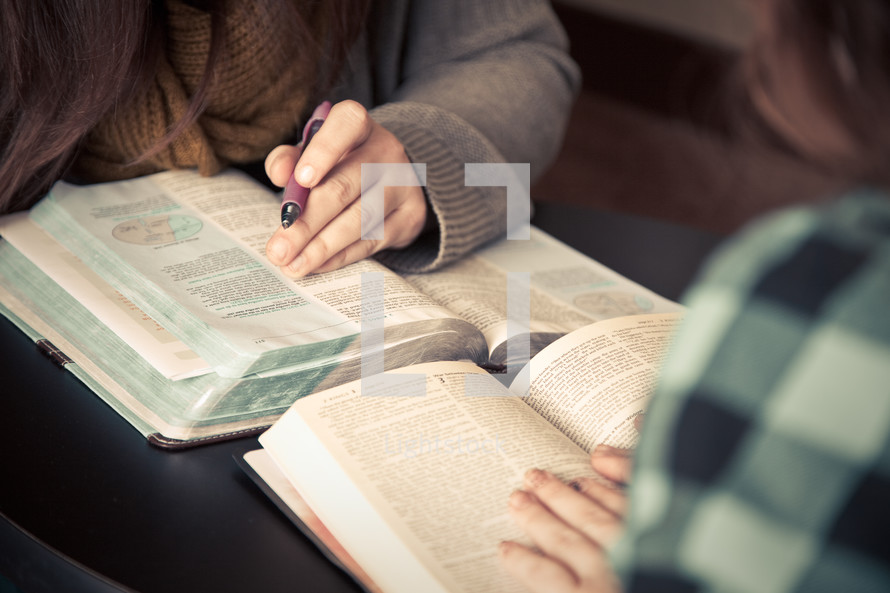 women reading from the Bible at a Bible study