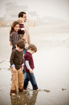 a family standing on a beach 
