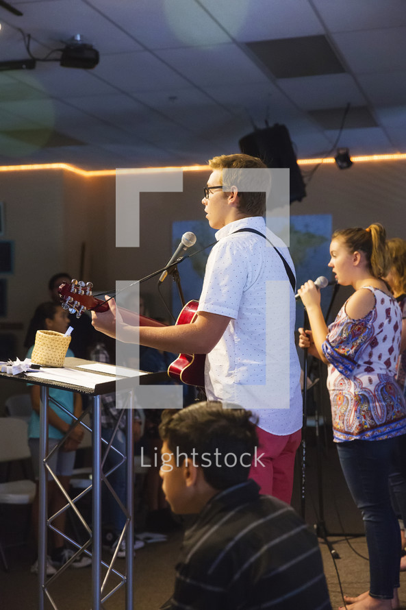 teens singing during a worship service 