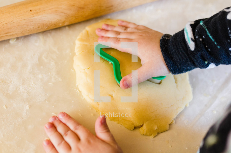 little boy baking christmas sugar cookies 