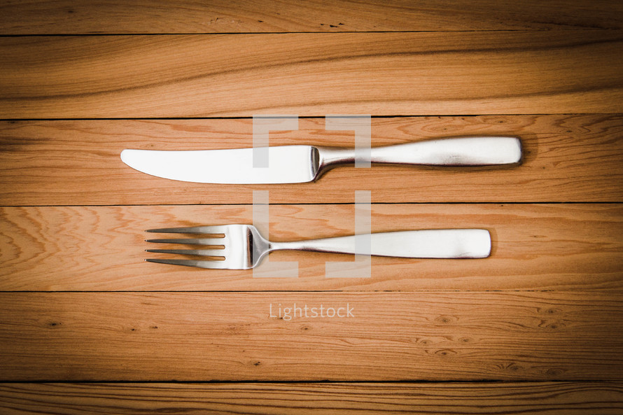 fork and knife on a wood floor 