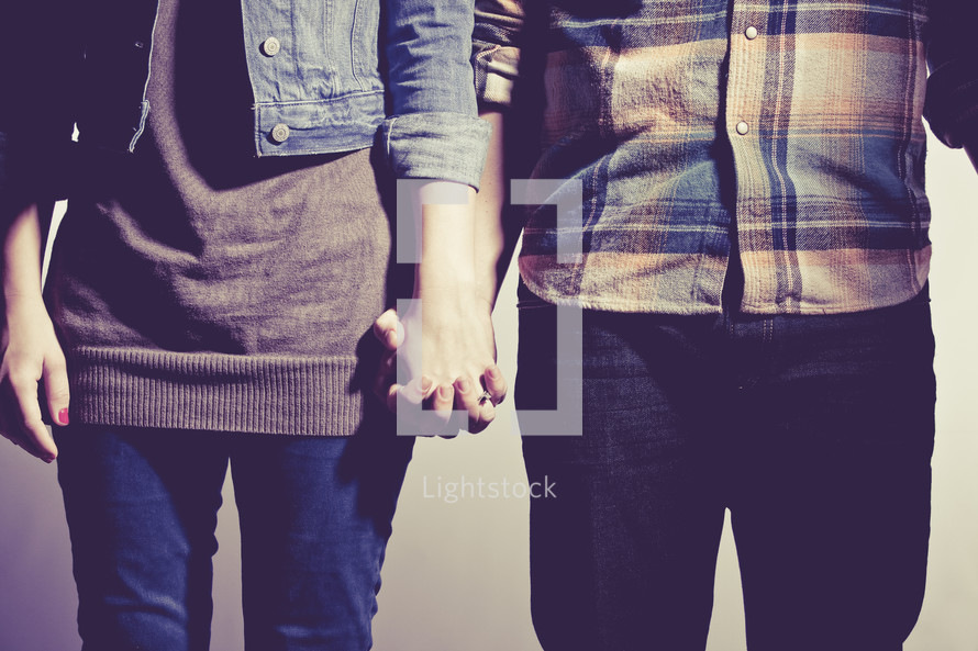 couple holding hands in prayer