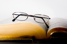Glasses on an open bible.