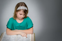 Girl reading the Bible.