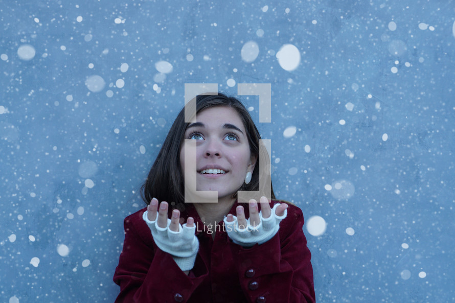 a teen girl catching snow 