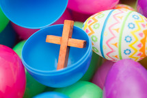 plastic Easter eggs filled with a small wooden cross