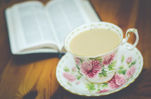 tea cup and saucer and open Bible 