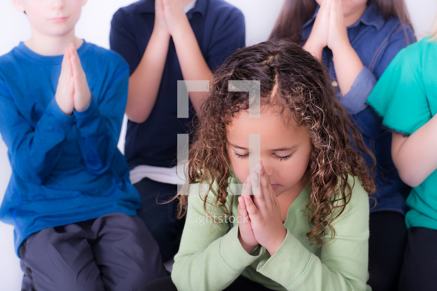 Children praying together.