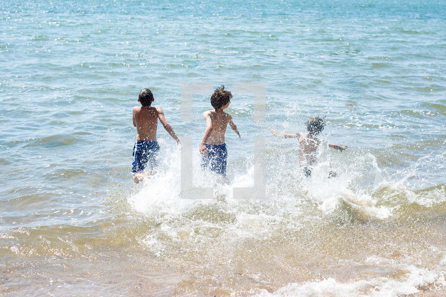 Kids splashing in the ocean waves.