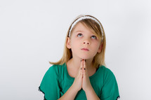 Girl praying while looking to heaven.