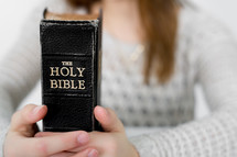 A teen girl holding a Bible 