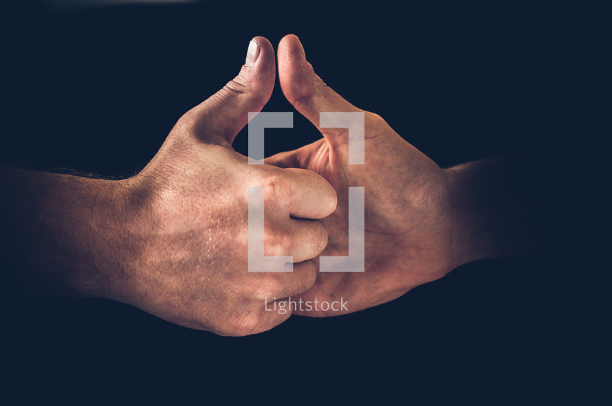 Two hands engaging in Thumb War