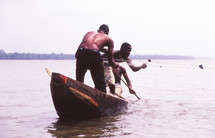 fishermen in a wooden boat 