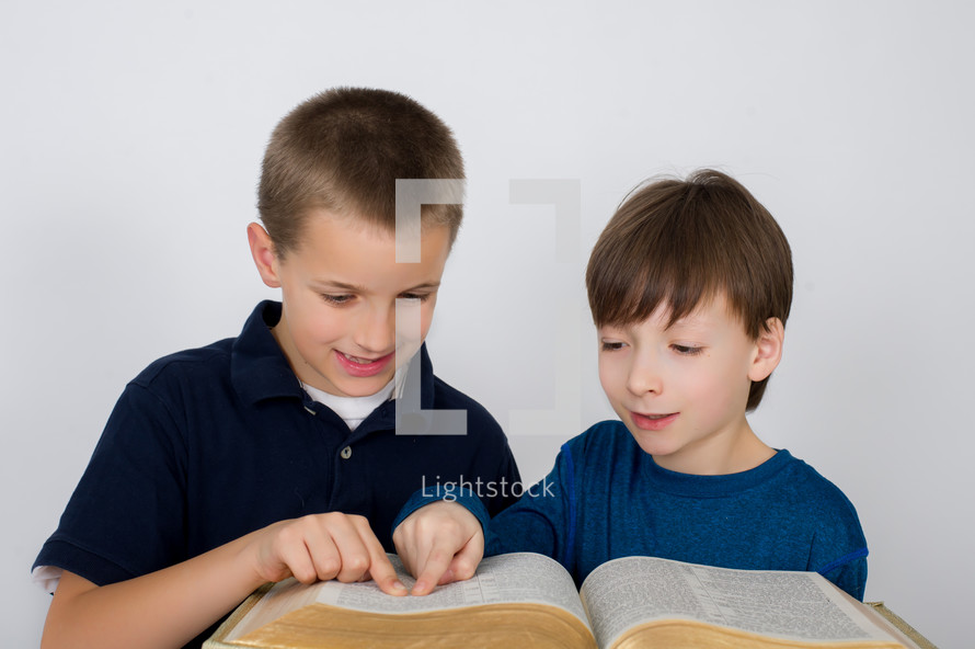 Boys reading the Bible together.