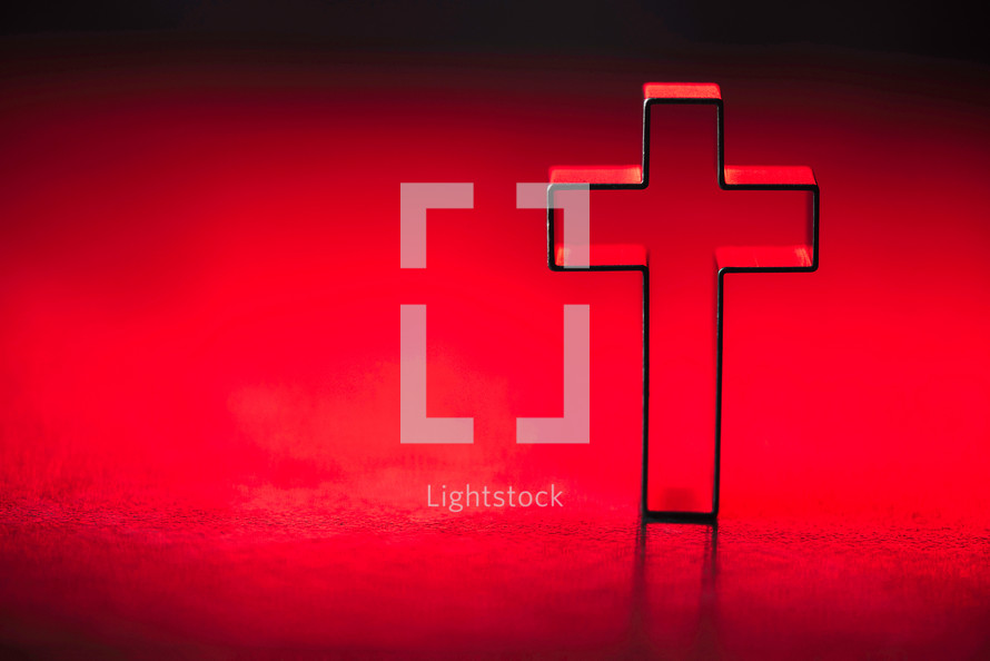 Silhouette of christian cross on soft lights background. Copy space. 