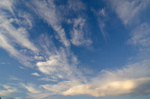 wispy white clouds in a blue sky