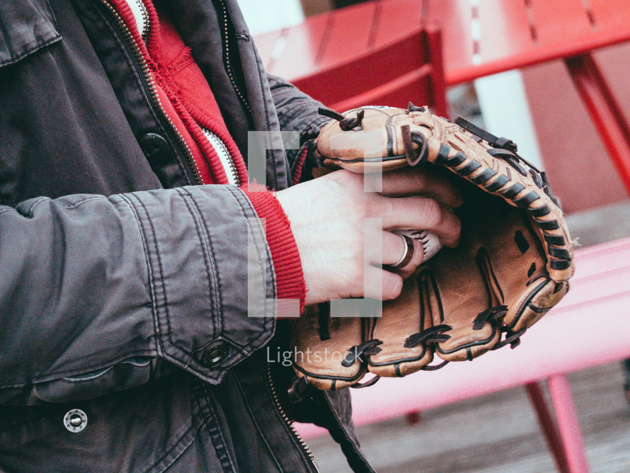 Man with baseball glove and ball.