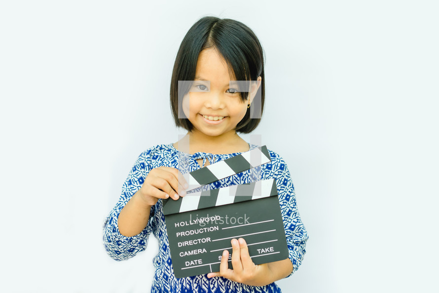 girl holding a clapper board 