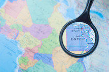 magnifying glass over a map of Egypt 