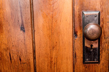 Wooden door with a door knob.