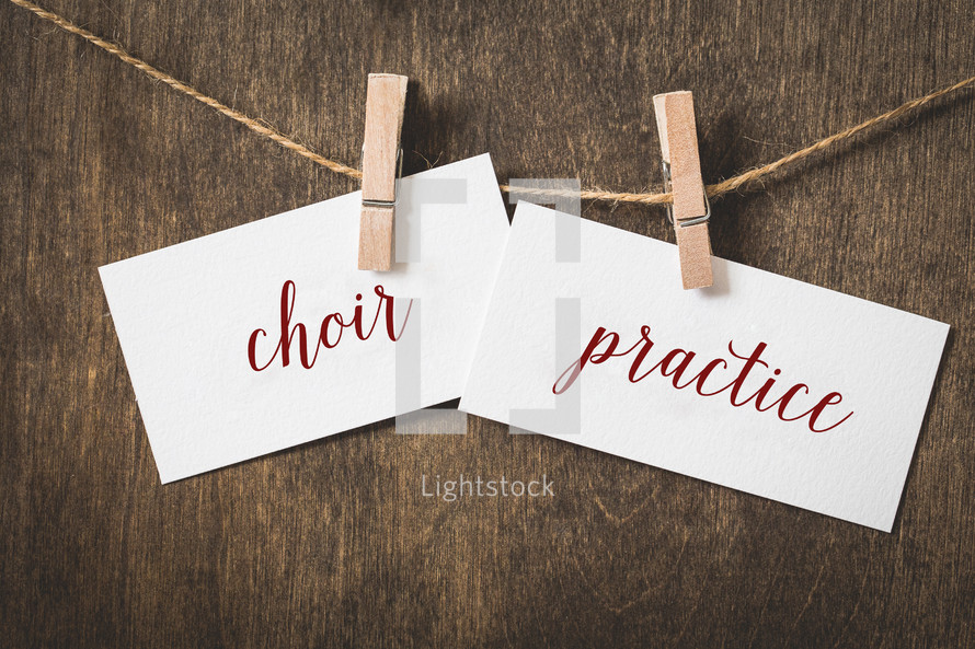 word choir practice  on card stock hanging on twine by a clothespin 