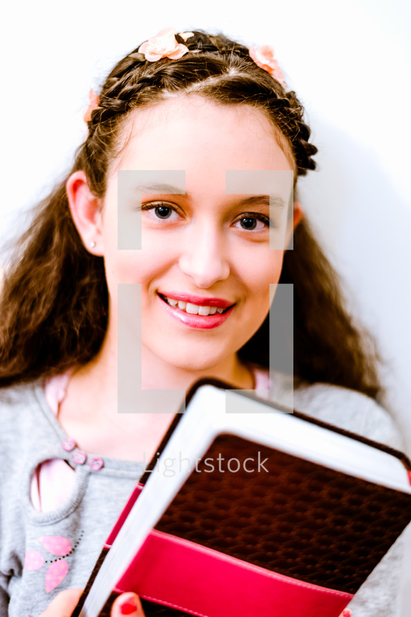 teen girl holding a Bible 