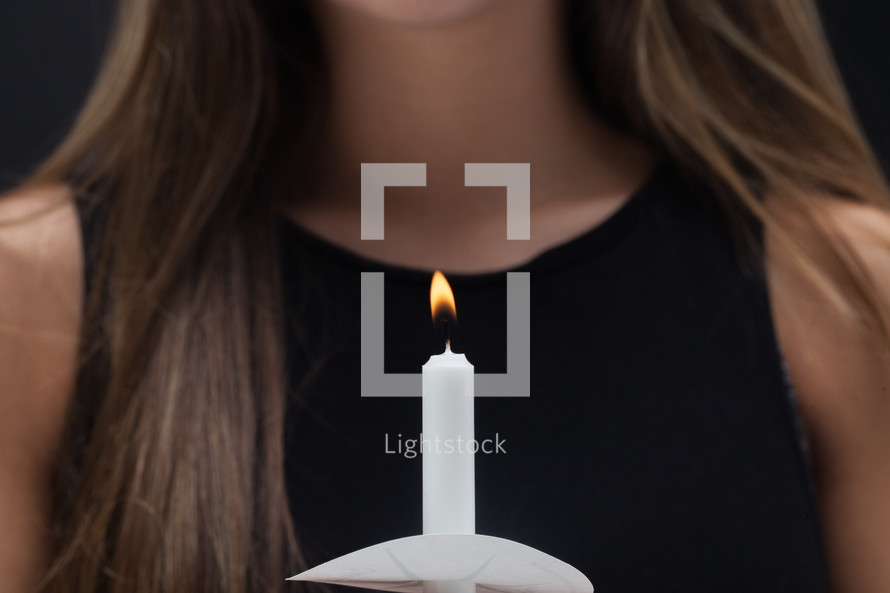 young woman holding a candle 