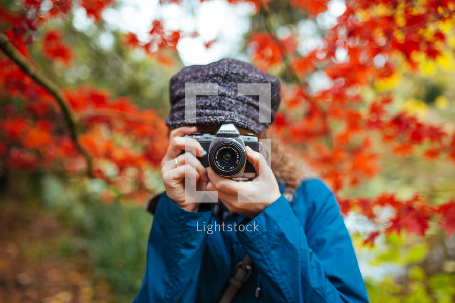 a woman with a camera taking a picture 
