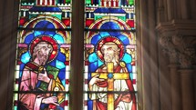 Biblical figures in colorful stained glass.