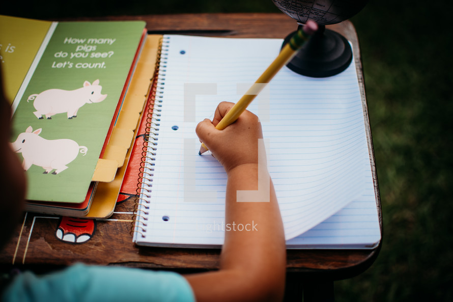 a child doing homework outdoors 