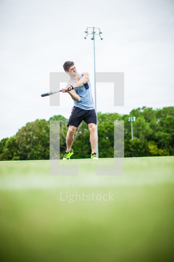 a man swinging a baseball bat 