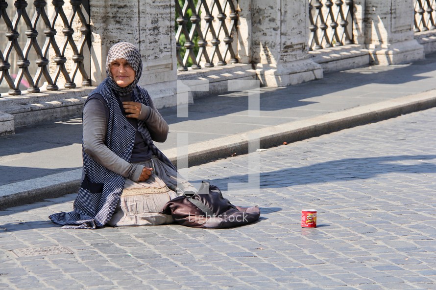 a woman begging on the streets in Rome 