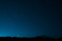stars in the night sky over mountains 