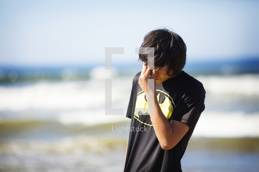 stressed boy on a beach 