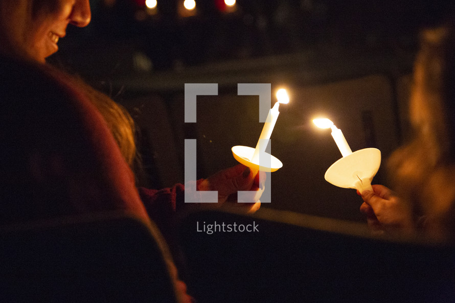lighting candles during a candlelight service 
