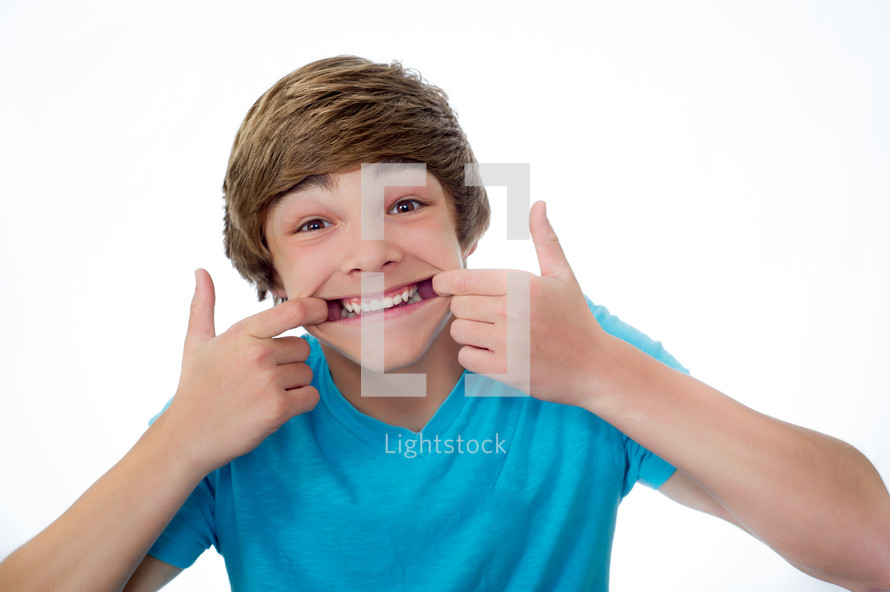 teen boy showing his teeth