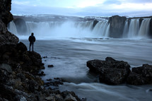 person watching a waterfall in Iceland 