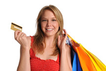 retail therapy - woman holding shopping bags and credit cards 