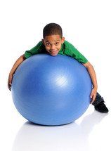 boy playing with a large blue ball 