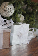 beautifully wrapped white gift under tree