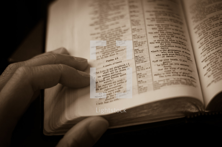 hand on the pages of a Bible - Psalm 23