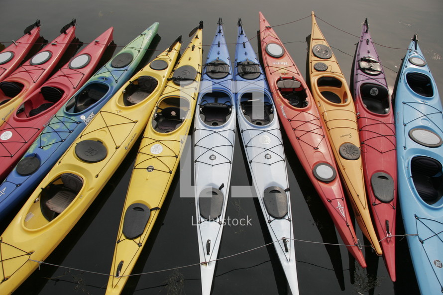 Colorful kayaks in the water.