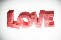 word LOVE in red and glitter letters