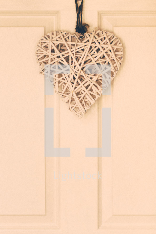 basket weave heart hanging on a door 