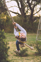 girl child on a rope swing 