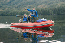 people pointing while floating on a raft 