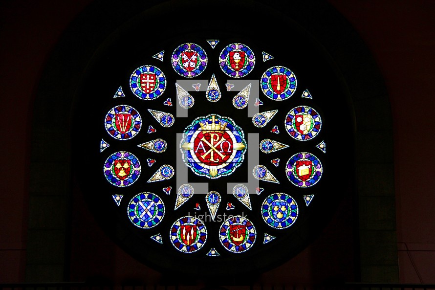 Circular stained glass window depicting the signs of each of the 12 disciples in an Anglican Cathedral