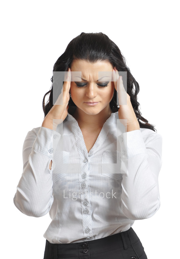 Woman with her hands pressed to her temples as if she has a headache.