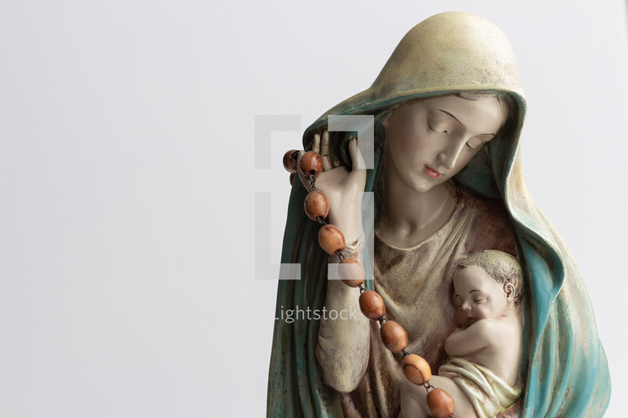 statue of Mary and baby Jesus with a rosary 