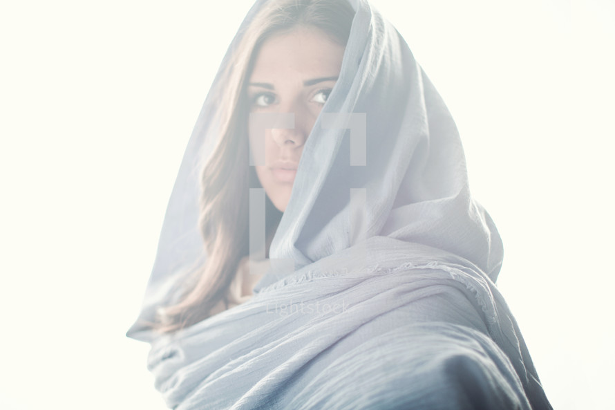 Mary in a blue shroud in bright light